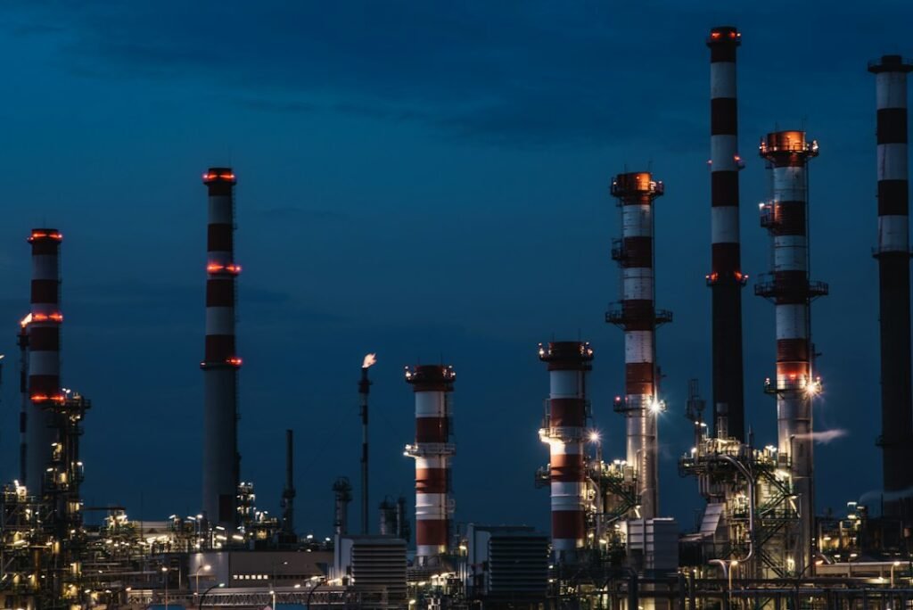 Refinery process units, towers and pipework at dusk