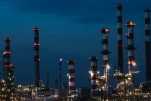 Refinery process units, towers and pipework at dusk