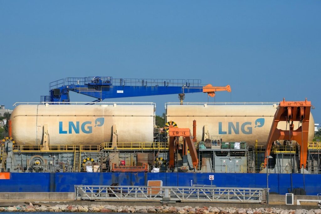 Illustrative LNG tank transport scene; not the Ksi Lisims project site.