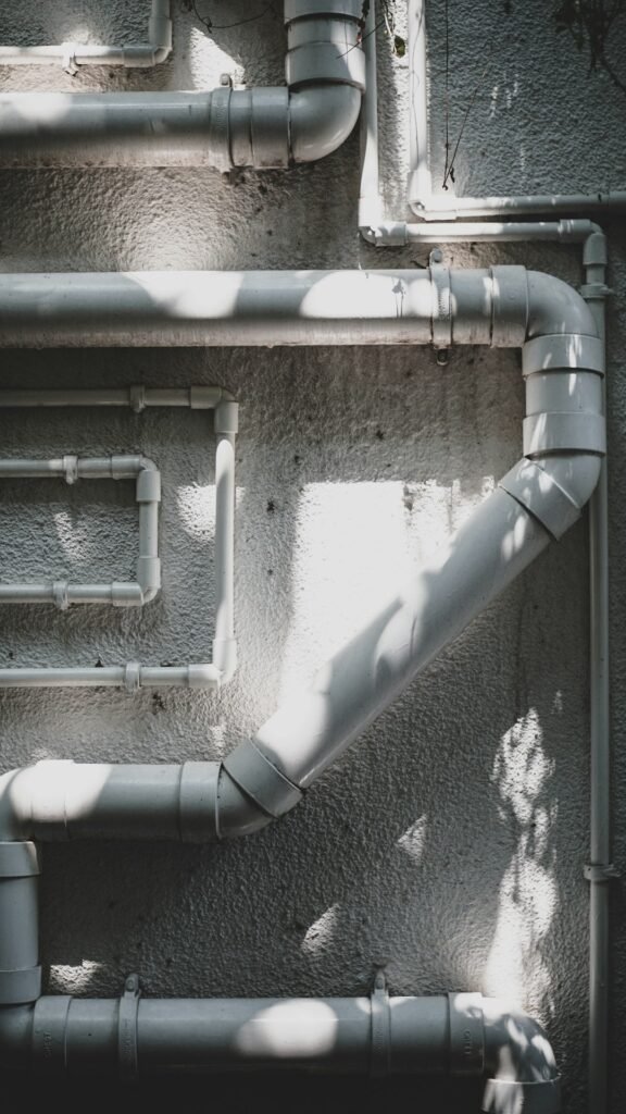 Stock photograph of industrial pipework for fluid-equipment context; not an SLB facility or product.